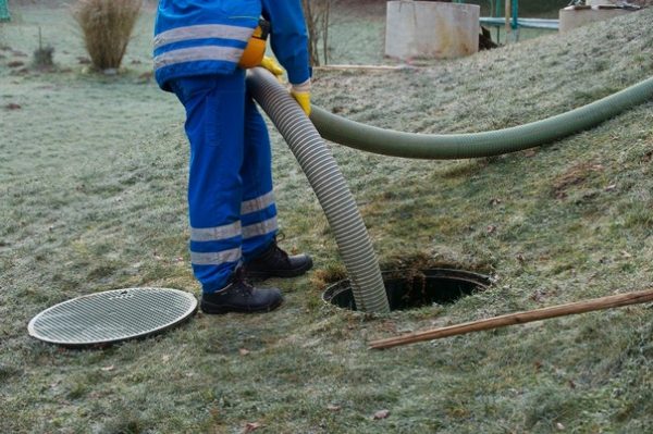 Emptying household septic tank. Cleaning sludge from septic system.